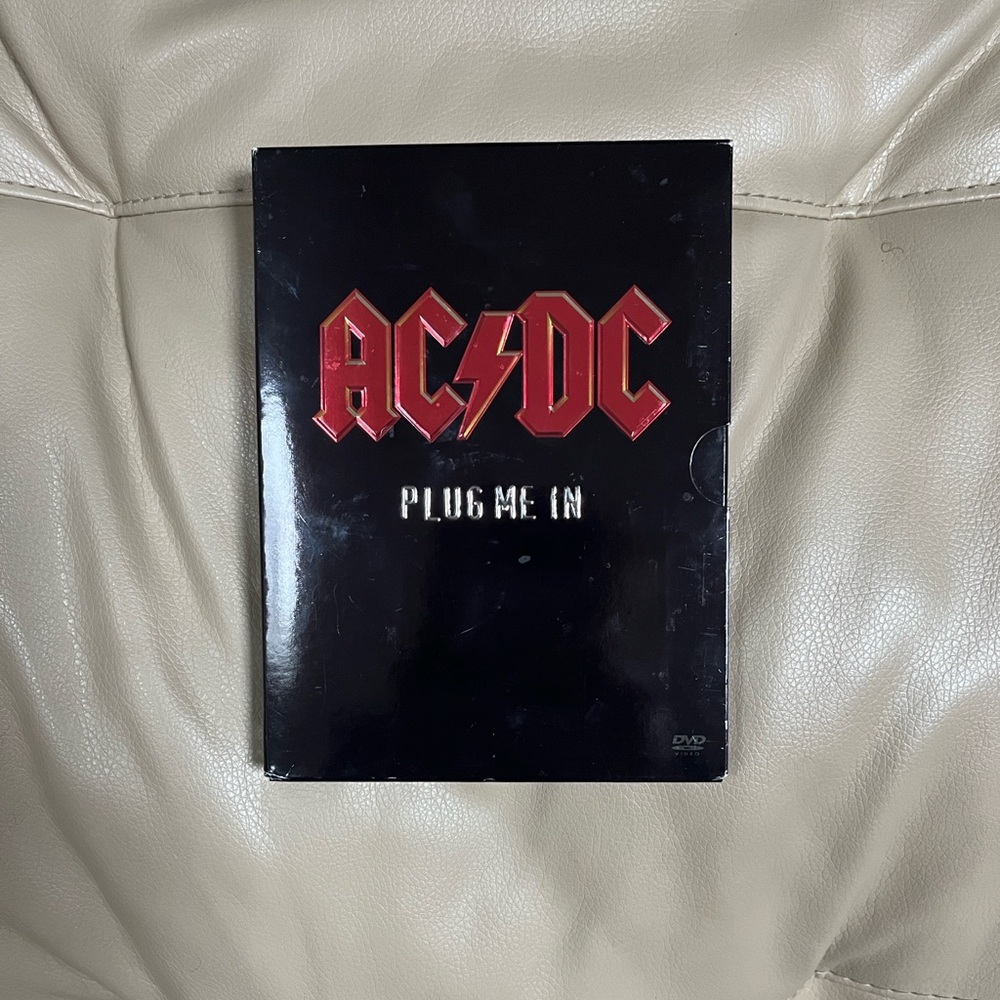 AC/DC Plug Me In DVD with Red and Black Cover